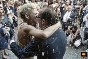 In Faenza, Emilia Romagna, Italy, outside the city cathedral, the newlyweds share a kiss beneath a shower of rice. A slow shutter captures the motion, creating a dreamy, celebratory atmosphere full of romance.